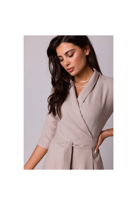 Rozkloszowana sukienka kopertowa z wiązaniem w pasie beżowa